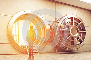 Man in suit entering the sunlit vault