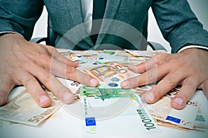 Man in suit with euro bills photo