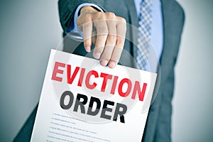 Man in suit with an eviction order photo