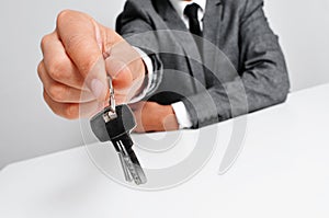 Man in suit giving the keys