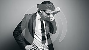 Man in a suit and glasses. touches his forehead in confusion. photo in negative