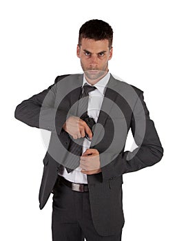 Man in a suit grabbing gun