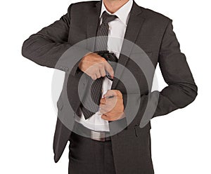 Man in a suit grabbing gun