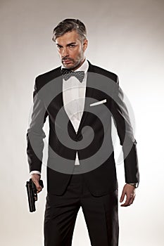 Man in a suit with a gun