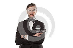 Man in a suit with a gun