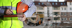 Man in suit with helmet closeup in costruction area