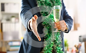 Man in suit hold champagne goblet give arm as hello