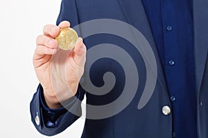 Man in suit holding gold bitcoin coin isolated on white background. Copy space and mock up. Selective focus and business success