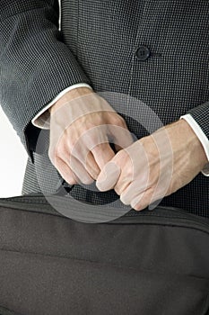 Man in suit holding laptop case