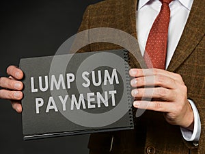 A man in a suit holds an inscription Lump sum payment. photo