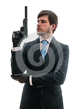 Man in suit holds pistol with silencer in hand. Isolated on white background photo