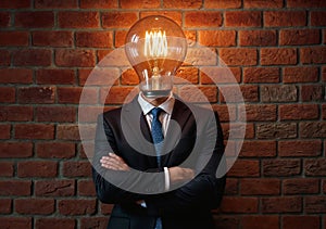 A man in a suit with a lightbulb in place of his head.