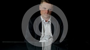 Man in suit looking at balaclava, preparing to commit crime, doubtfulness photo