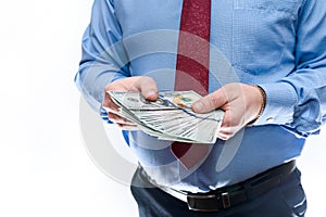 Man in suit offering dollar banknotes close up