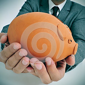 Man in suit with a piggy bank photo