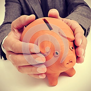 Man in suit with a piggy bank photo