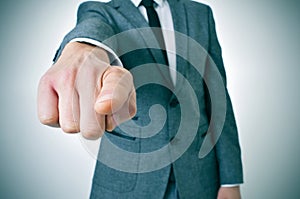 Man in suit pointing the finger