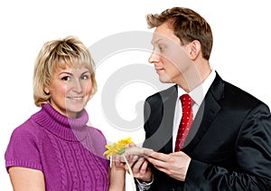 Man in suit presents daisywheel to woman