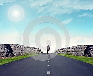 Man in suit on road with mountains