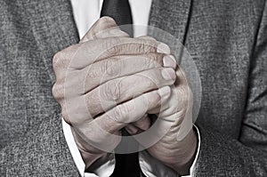 Man in suit rubbing his hands