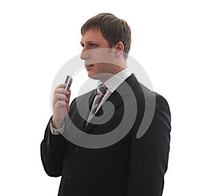 A man in a suit says in a digital voice recorder.