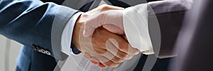 Man in suit shake hand as hello in office closeup