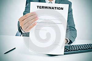 Man in suit showing a figured signed termination document