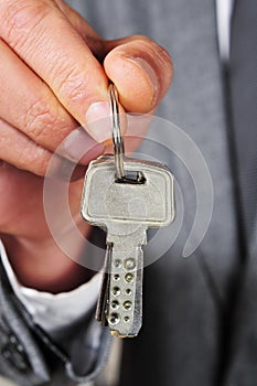 Man in suit showing a key ring