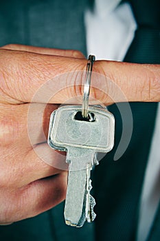 Man in suit showing a key ring