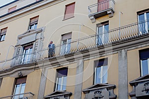 Man in a suit smoking on the balcony in Venice, Italy