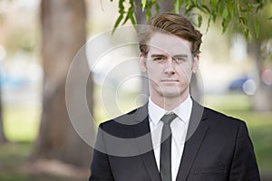 Man in suit standing in park