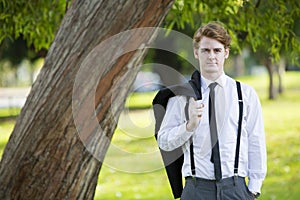 Man in suit standing in park