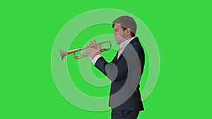 Man in suit standing playing trumpet on a Green Screen, Chroma Key.