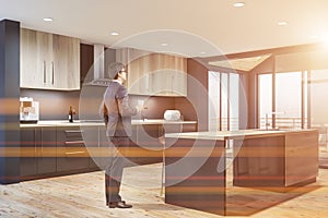 Man in suit in stylish gray kitchen