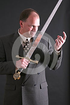 Man in a suit with a sword motioning 'come here'