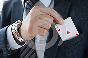 Man suit takes an ace card from his jacket pocket