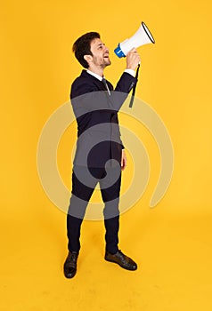 A man in a suit with a tie Handsome looking face with beard In the business man look Holding a megaphone To announce news or