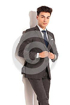 Man in suit and tie unbuttoning his coat