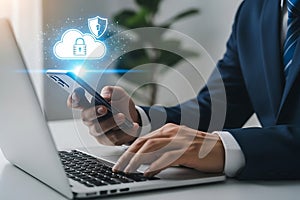Man in suit using smartphone and laptop with cloud security graphic technology cloud computing