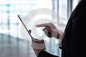Man in a suit using tablet. Businessman with smart mobile device