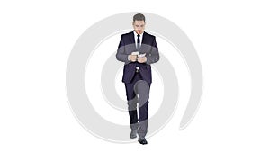 Man in suit walking and counting money on white background.