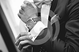 Man with suit and watch on hand