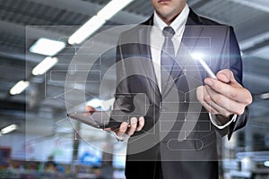 Man in a suit works with a flowchart on a virtual computer screen