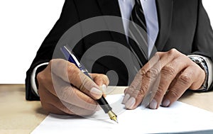 Man in suit writing on blank paper from front view angle