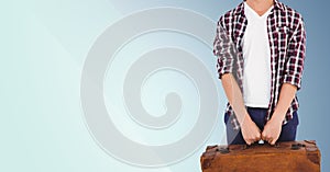 Man with suitcase standing against blue background