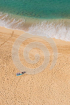 Man sun bathing solo on secluded beach