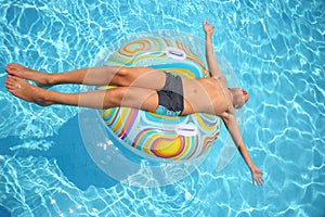 Man sunbathes lying on an inflatable toy