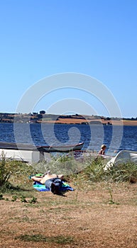 Man sunbathing by sea