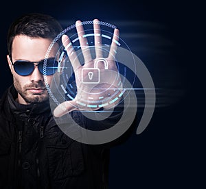 Man in sunglasses controls virtual system by hand.