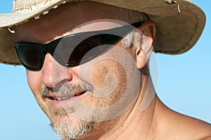 Man with sunglasses and hat photo